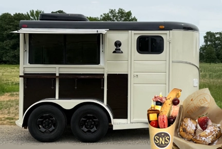 Food truck with charcuterie cups and gourmet grilled cheese sandwiches.